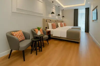 a bedroom with a bed and a table and chairs at Center Port Hotel Karaköy in Istanbul