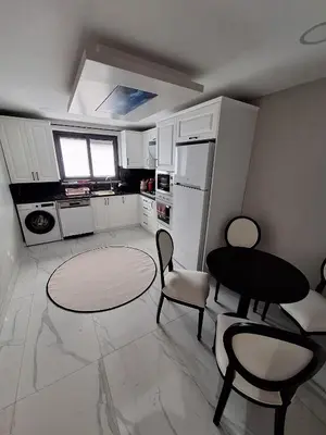 a kitchen with a table and chairs and a refrigerator at Daly Resort 1 in Sapanca