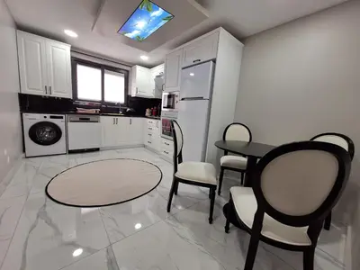 a kitchen with a table and chairs in it at Daly Resort 1 in Sapanca