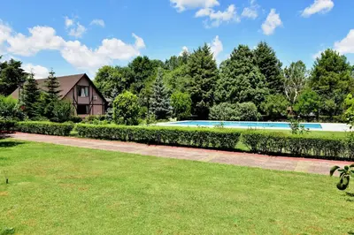 a garden with a swimming pool and a house at Villa Riva Garden in Polonezkoy