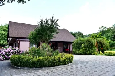 a house with a flower garden in front of it at Villa Riva Garden in Polonezkoy