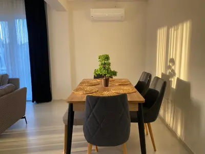 a dining room with a table with a plant on it at One Suit in Kartepe