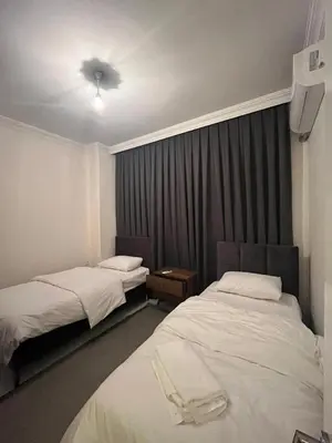a hotel room with two beds and a ceiling fan at One Suit in Kartepe