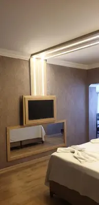 a room with two beds and a flat screen tv at City Light Otel in Istanbul