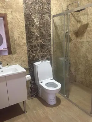 a bathroom with a toilet and a shower and a sink at City Light Otel in Istanbul