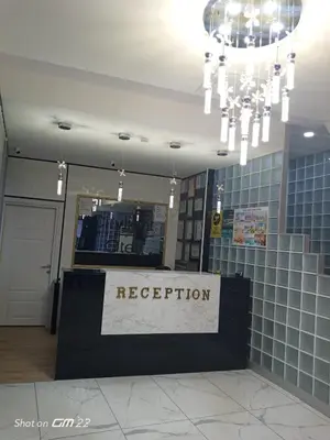 a reception desk in a building with a chandelier at City Light Otel in Istanbul