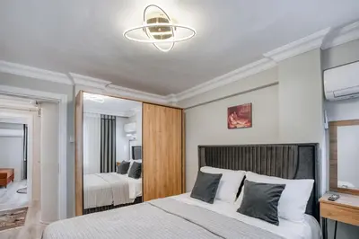 a bedroom with a large bed and a mirror at SULTANAHMET oldcity nice suite in Istanbul