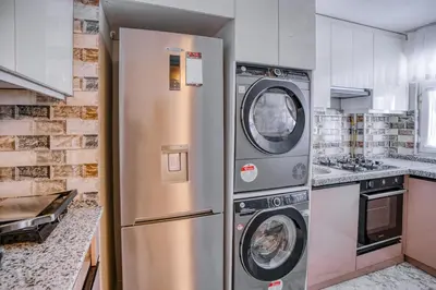 a kitchen with a stainless steel refrigerator and washing machines at SULTANAHMET oldcity nice suite in Istanbul