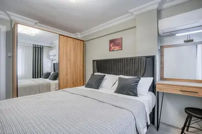 a bedroom with two beds and a mirror at SULTANAHMET oldcity nice suite in Istanbul