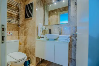 a bathroom with a sink and a toilet at Istiklal Nil Suites in Istanbul