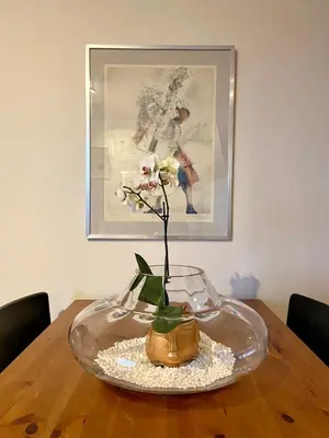 a glass vase with a flower in it on a table at A million dollar view of the Bosporus and balcony in Istanbul