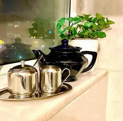 a tray with two tea pots and a tea kettle at A million dollar view of the Bosporus and balcony in Istanbul