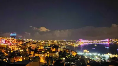 a view of a city at night with a bridge at A million dollar view of the Bosporus and balcony in Istanbul