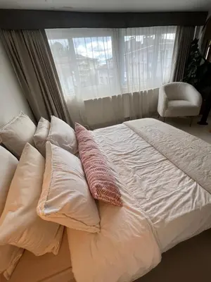a bed with white sheets and pillows in front of a window at Lobby No23 in Istanbul