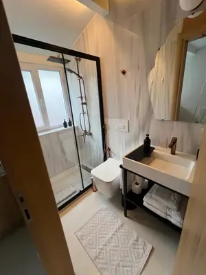 a bathroom with a shower and a sink and a toilet at Lobby No23 in Istanbul