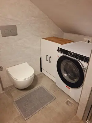 a bathroom with a washing machine and a toilet at Kadir Bey Apt in Istanbul