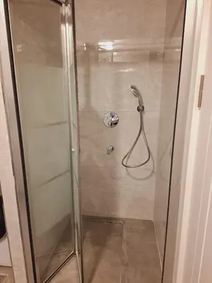 a shower with a glass door in a bathroom at Kadir Bey Apt in Istanbul