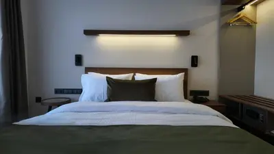 a bedroom with a large bed with white pillows at Yıldız Termal Otel in Çekirge İstasyonu