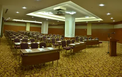 a conference room with rows of chairs and a podium at Adranos Hotel in Bursa