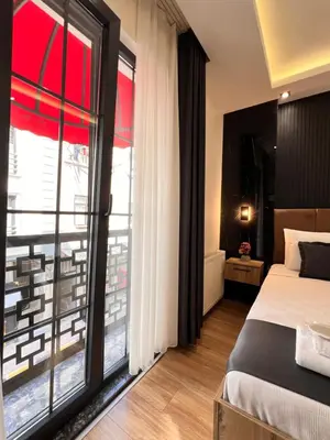 a bedroom with a bed and a large window at The Bail Hotel in Istanbul