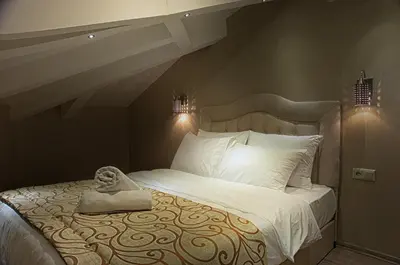 a bedroom with a large bed with a towel on it at Best Fulya Suites in Istanbul