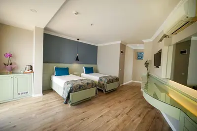 a bedroom with two beds with blue pillows at White Palace Apart in Istanbul