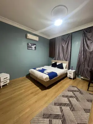 a bedroom with a bed with blue walls and wooden floors at Taksim White Mansion Hotel in Istanbul