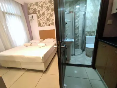 a bathroom with a bed and a shower and a tub at Grafen Hotel in Istanbul