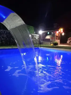 a water fountain in a swimming pool at night at Sakarya Sapanca da Özel Havuzlu , Ailelere Özel Villalar in Sapanca