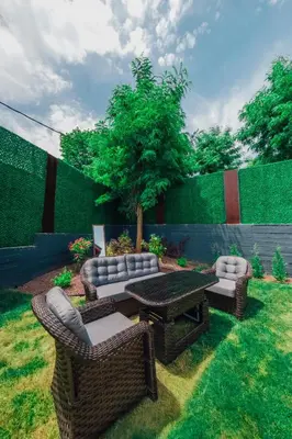 a patio with a table and couches and a tree at Kartepe Maşukiye de 2 oda1 salon Özel Havuzlu - Şömineli -Muhafazakar 5 Kişilik Bungalov in Korfez