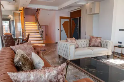 a living room with two couches and a staircase at Comfort 4 bedroom villa yalova see view in Yalova