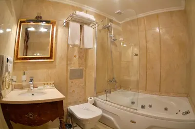a bathroom with a sink and a toilet and a tub at Arden City Hotel-Special Category in Istanbul