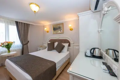a hotel room with a bed and a desk at Arden City Hotel-Special Category in Istanbul