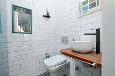 a white bathroom with a sink and a toilet at Exclusive House with 2 Apartments including 4 Bedrooms and 4 Bathrooms in Total in Istanbul