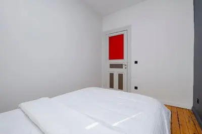 a white bed in a room with a red window at Exclusive House with 2 Apartments including 4 Bedrooms and 4 Bathrooms in Total in Istanbul