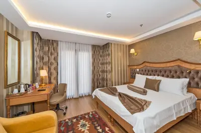 a hotel room with a bed and a desk at Aprilis Gold Hotel - Special Category in Istanbul