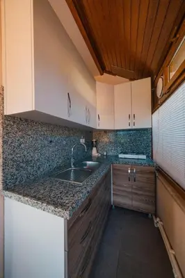 a kitchen with white cabinets and a sink at Sepetçi Lakehouse Heated Pool in Kartepe