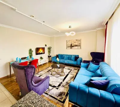 a living room with a blue couch and chairs at Apartment in Sisli Mado14 in Istanbul