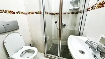 a bathroom with a shower and a toilet and a sink at Apartment in Sisli Mado14 in Istanbul