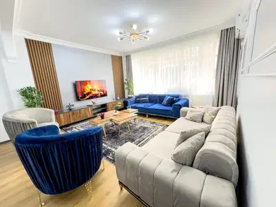 a living room with a couch and blue chairs at Sisli 3 41 in Istanbul