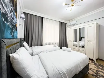 a bedroom with a white bed and a mirror at Sisli 3 41 in Istanbul