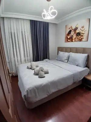a bedroom with a large bed with two pillows on it at شقه الأحلام بمنطقة شيشلى ثلاث غرف وصالون in Istanbul