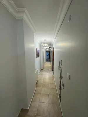 a hallway with white walls and a tile floor at شقه الأحلام بمنطقة شيشلى ثلاث غرف وصالون in Istanbul