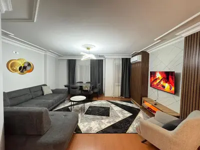 a living room with a couch and a tv at Luxurious apartment in Sisli area, three rooms and a living room in Istanbul