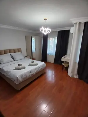 a bedroom with a large bed and a piano at Luxurious apartment in Sisli area, three rooms and a living room in Istanbul