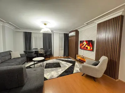 a living room with a couch and chairs and a tv at Luxurious apartment in Sisli area, three rooms and a living room in Istanbul