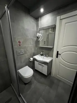 a small bathroom with a toilet and a sink at Nexus By Taksim Hotel in Istanbul