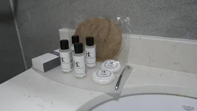 a bathroom with a toilet with four bottles on it at Karadeniz Hotel Çorlu in Corlu