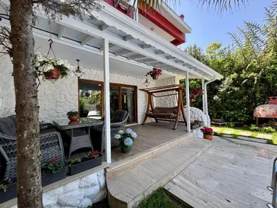 a wooden deck with a pergola on a house at Villa Luna Sapanca in Sakarya