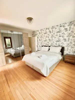 a bedroom with a large white bed and a mirror at Villa Luna Sapanca in Sakarya